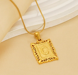 Detailed view of golden snake chain necklace with square embossed letter C pendant