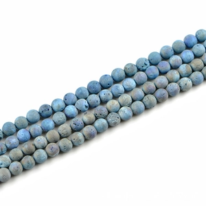 Macro detail of 10mm frosted blue natural stone beads with iridescent metallic luster