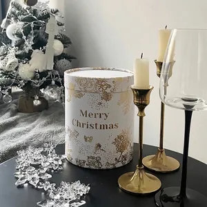 Boîte cadeau de Noël cylindrique blanche avec motifs de roses dorées et vœux de Noël