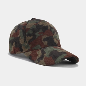 Close-up of camouflage corduroy fabric texture and curved brim on the baseball cap