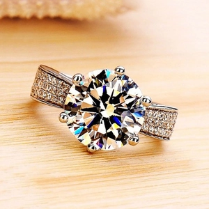 Classic six-prong solitaire ring with brilliant round zircon and pave-set diamond band