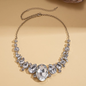 Detail showing oversized oval and teardrop crystal necklace with sparkling rhinestones