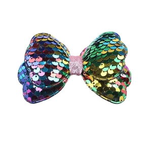 Kids colorful sequin bow hair clip with pink glitter center on white background