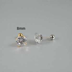 Detail of 8mm cubic zirconia stud earrings with gold and silver four-prong settings