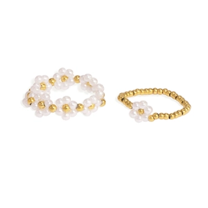 Elegant gold beaded ring set with pearl flower accents on a clean white background
