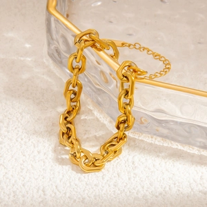 Close-up of 18k gold plated chunky titanium steel chain bracelet with extension link