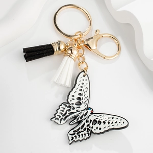Acrylic butterfly keychain with black and white hollow pendant and matching tassels