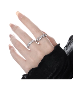 Detailed view of sterling silver twisted knot and frosted textured rings on finger