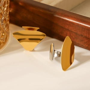 Macro shot of minimalist geometric wide gold and silver stainless steel rings with mirror finish