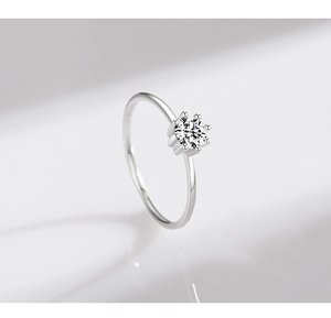 Macro shot of silver S925 sterling silver ring with six-prong set solitaire zircon