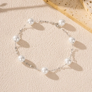 Elegant S925 sterling silver pearl bracelet with white crystals on a textured background
