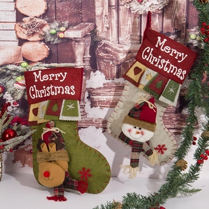 Two Christmas stockings with 3D reindeer and snowman on a rustic wooden background