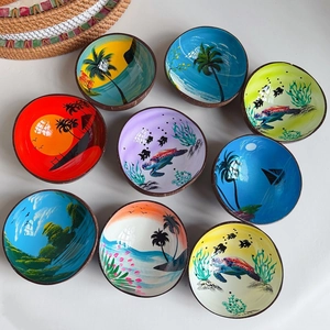 Top view of nine handcrafted coconut bowls featuring tropical hand-painted art interiors