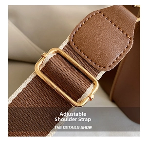 Detail of adjustable brown woven shoulder strap with premium gold metal buckle