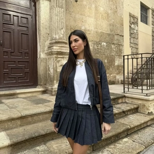 Women's retro dark grey denim jacket and pleated skirt set in a vintage street style