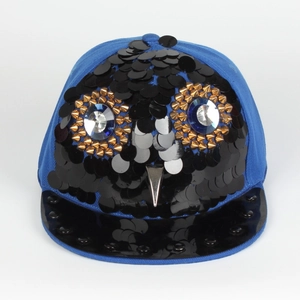 Detail of sequin owl design with gold spikes and gem eyes on a blue hip-hop snapback cap