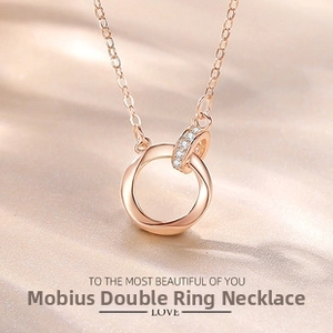 Detail of rose gold Mobius double ring necklace with shimmering cubic zirconia stones