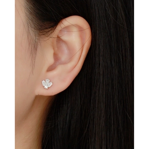 Close-up of S925 silver piercing stud featuring baguette zircon stones on an earlobe
