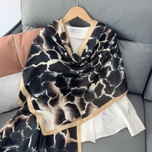Elegant cotton linen scarf with black and brown animal print and golden border on white shirt