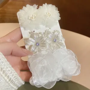 Elegant pearl and diamond flower stud earring set with three unique floral designs