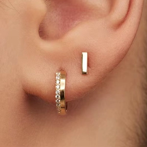 Macro shot of S925 silver gold-plated geometric hoop earrings with pavé zircons