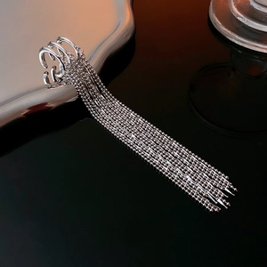 Detailed macro view of silver tassel chain ear cuff showing polished metallic luster
