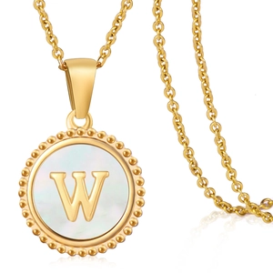 Detailed macro of golden 18K stainless steel shell pendant featuring the letter W