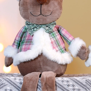Macro detail of Christmas reindeer plush with pink plaid coat and soft faux fur trim