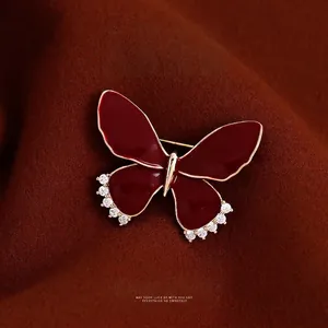Elegant deep red enamel butterfly brooch with gold plating and sparkling zircon crystals