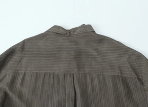 Detail of the brown striped fabric shirt showing the back collar and stitching quality