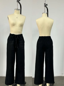 Front and back view of washed black wide-leg jeans with drawstring elastic waist and cat whiskers