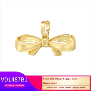 Detail view of 14mm x 25mm gold-plated brass bow pendant with MAMA inscription