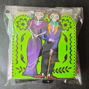 Detail of Day of the Dead skeleton party decorations inside clear plastic packaging