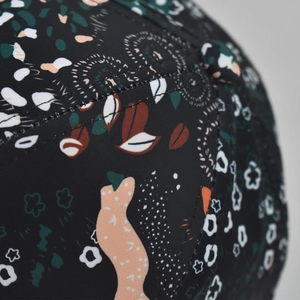 Detailed close-up of intricate tie-dye floral patterns and high-quality stitching on a cap