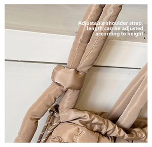 Detail of adjustable knotted shoulder strap on champagne quilted tote bag