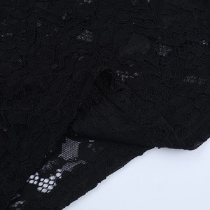 Macro shot of black sheer lace fabric detail with vintage floral pattern texture