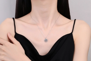 Close-up of S925 silver necklace with 1-carat moissanite double ring pendant on model