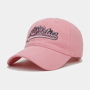 Detail view of pink cotton baseball cap featuring black Athletics script embroidery