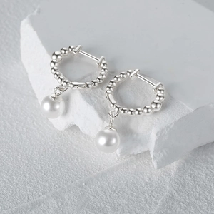 Detailed close-up of s925 silver beaded hoop earrings with elegant white pearl pendants