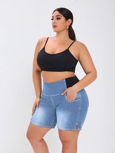 Detail of high waist denim print shorts and black racerback top on a fashion model