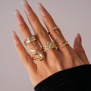 Detailed view of 6-piece gold geometric ring set with hammered and twisted textures