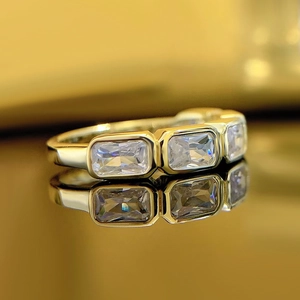 Elegant gold plated ring with rectangular baguette zircons and geometric band design