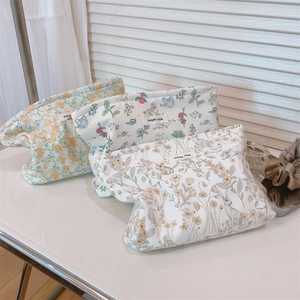Detailed close-up of floral and rabbit pattern cotton fabric pouches with brand label