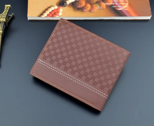 Detail of dark brown leather wallet featuring checkered embossing and contrast stitching