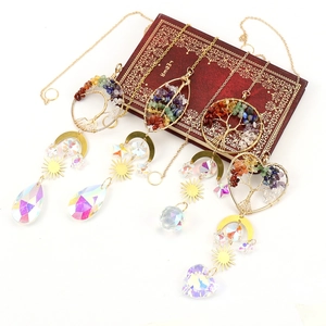 Golden tree of life suncatcher set with crystal prisms on vintage book display