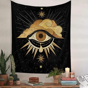 Detail of bohemian sun and moon tapestry with gold eye design and minimalist wall decor