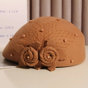 Detail of wool beret with handmade roses, dark mesh veil and golden pearl accents