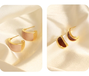 Detail of C-shaped crescent earrings in beige and brown enamel with gold finish