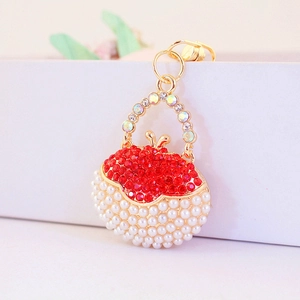 Cute handbag keychain with red rhinestones and faux pearls on gold metal frame