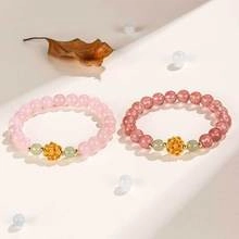 Detail of beaded gourd bracelets with gold hollow charms and pastel stones in retro style